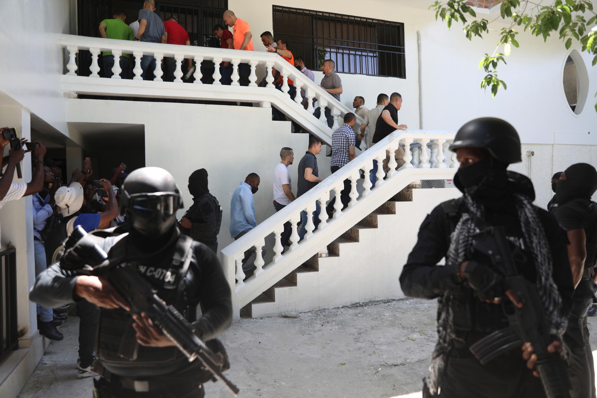 Colombians and Haitians who are accused of involvement in the 2021 assassination of Haitian President Jovenel Moise are escorted in handcuffs to their court hearing in Port-au-Prince, Haiti, May 26, 2025.