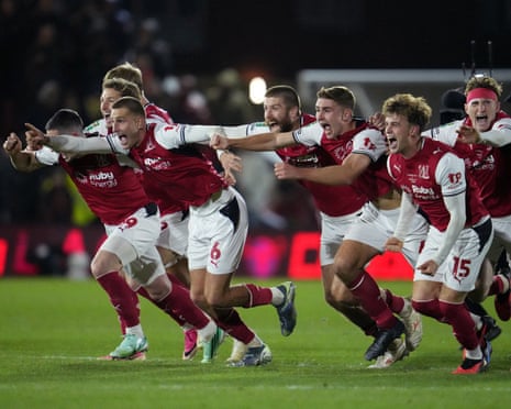 Rhys Bennett and teammates celebrate after Fleetwood’s penalty shootout win against Arsenal in the Carabao Cup.
