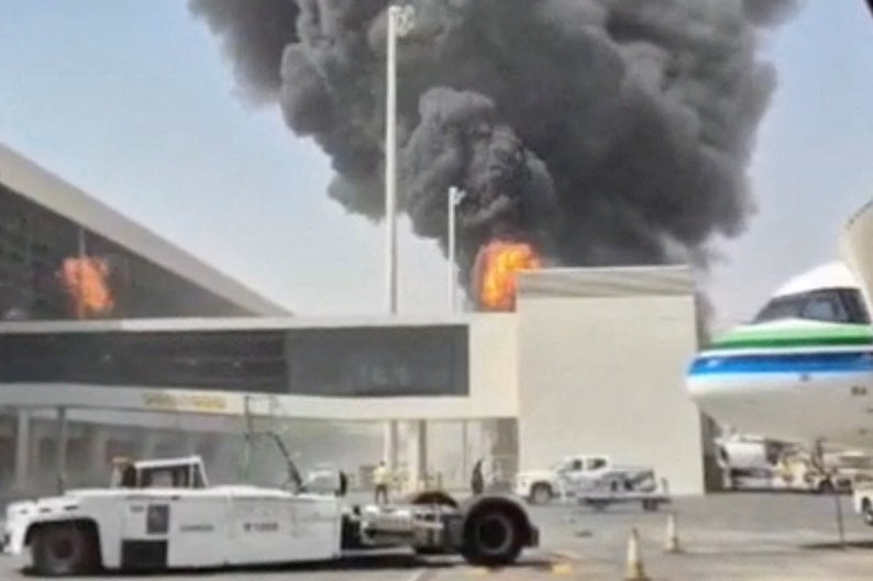 smoke and flames rise from an airport terminal
