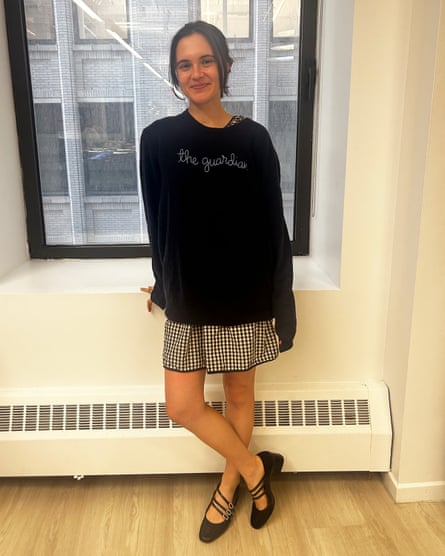 a woman in a sweater and a skirt