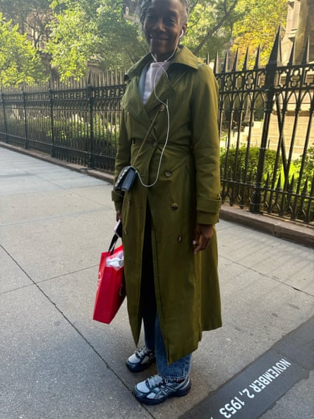 a woman in a green trench coat